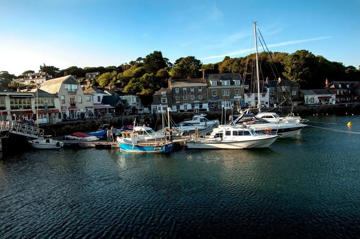 Scenic view of a harbor with yachts in a charming town, ideal for travel enthusiasts.