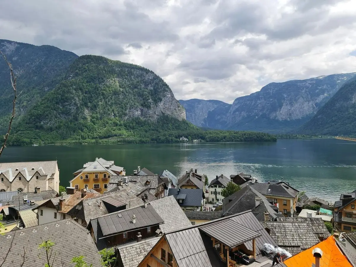 Aerial view of Hallstatt's charming rooftops, tranquil lake, and surrounding mountains in Austria.