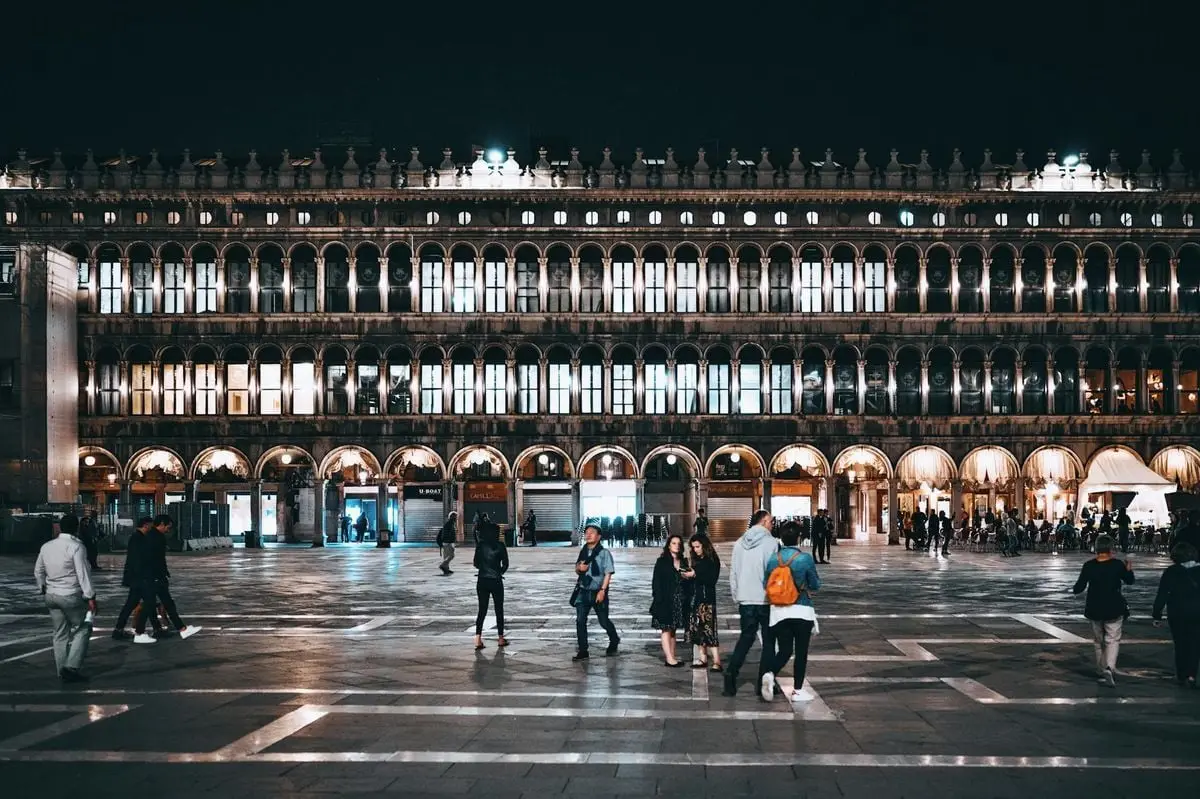 Tourists enjoying a night at Piazza San Marco in Venice, Italy.