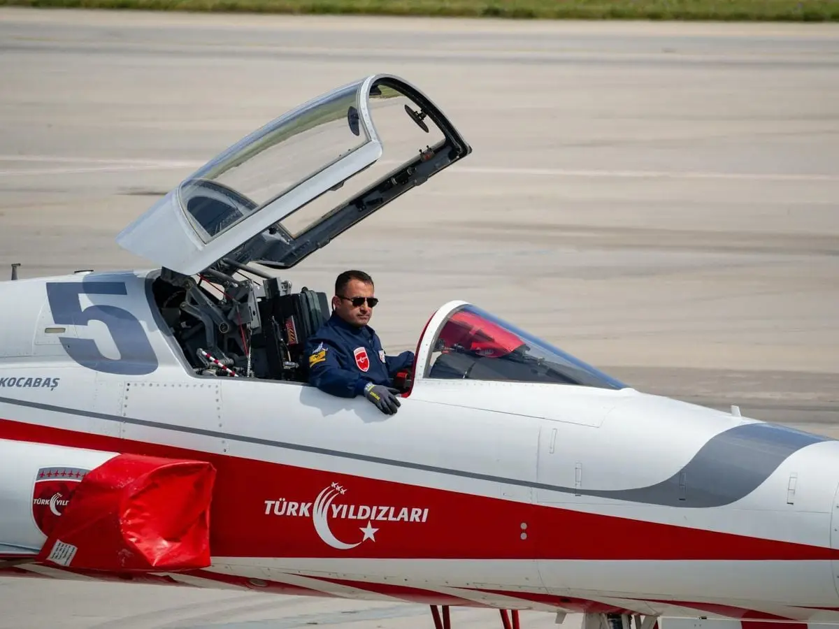 Pilot sitting in fighter jet cockpit, part of Turkish Stars aerobatic team in Istanbul.