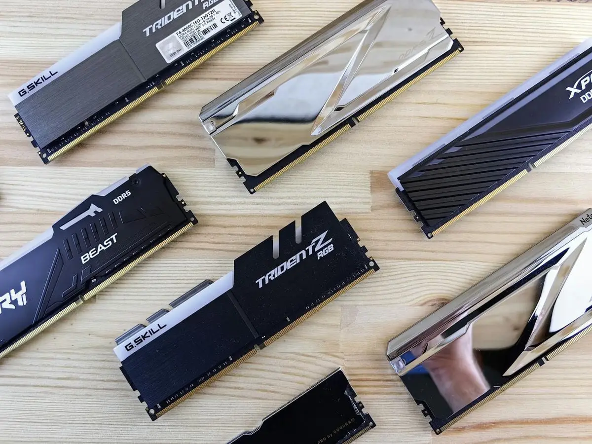 Top view of modern computer RAM sticks arranged on a wooden surface for technology enthusiasts.