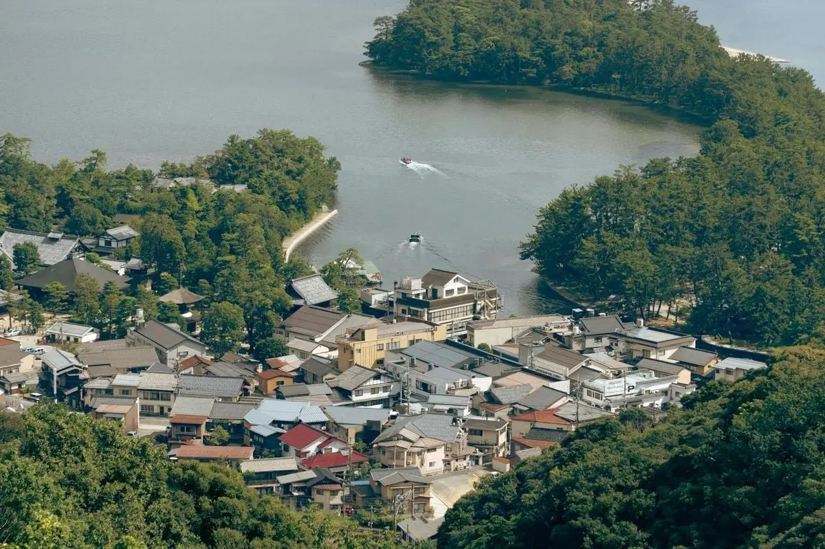Scenic aerial view of Miyazu town and bay surrounded by lush forests in Kyoto, Japan.