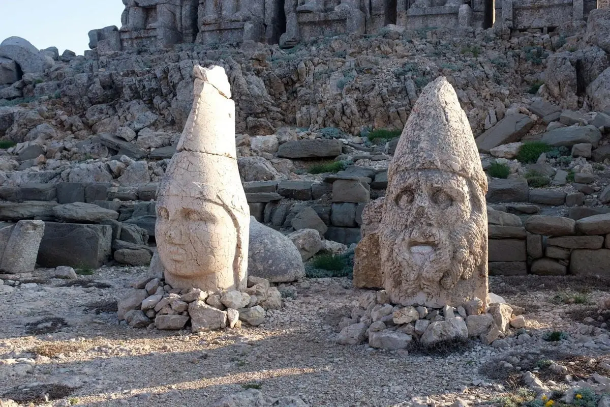 Weathered stone statues from Mount Nemrut, showcasing ancient Anatolian craftsmanship.