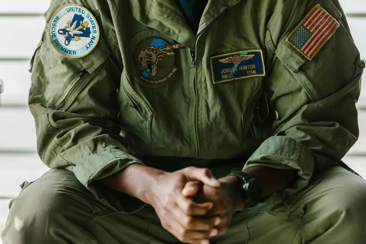Detail of a US military uniform showcasing patches indicating honor and bravery.