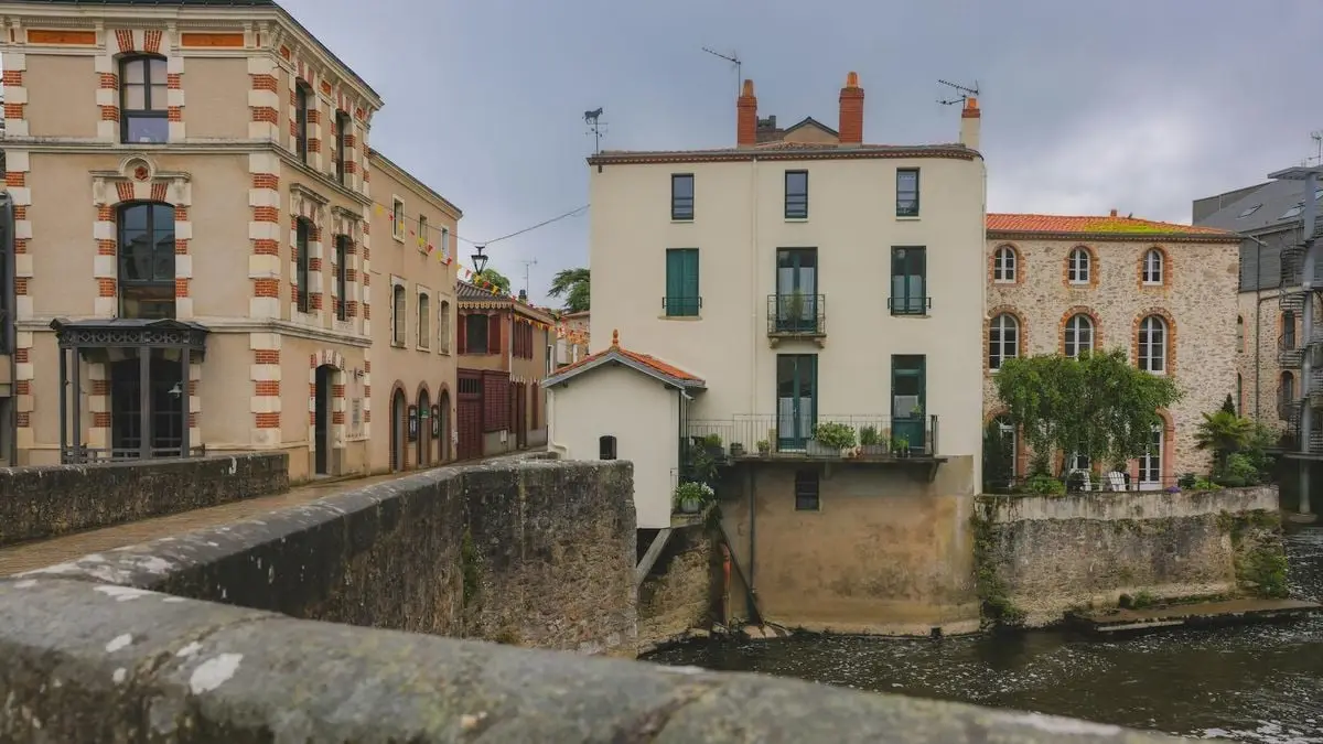 Charming historic architecture along the river in Clisson, Pays de la Loire, showcasing classic French design.
