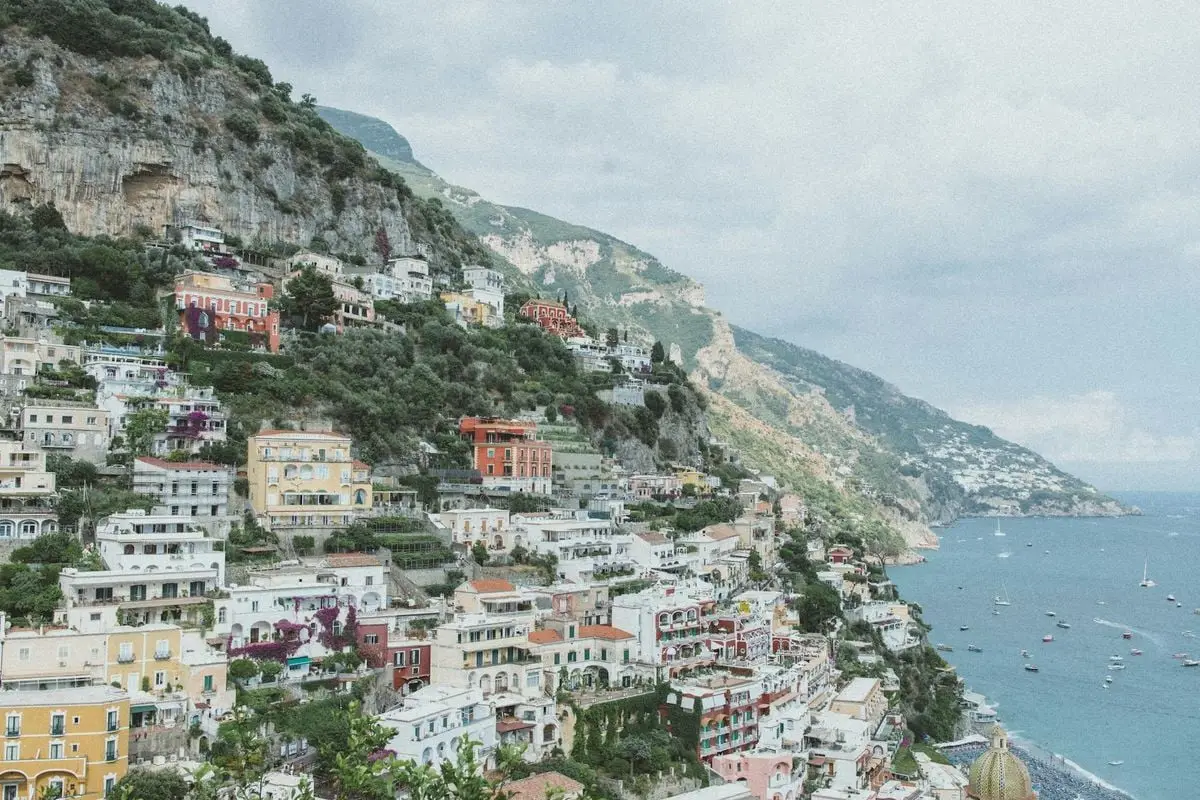 Discover the picturesque beauty of Positano, Italy, with its colorful cliffside houses and stunning coastal views.