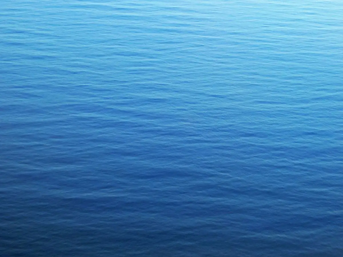 Calm blue ocean surface with gentle ripples, capturing serenity and tranquility.