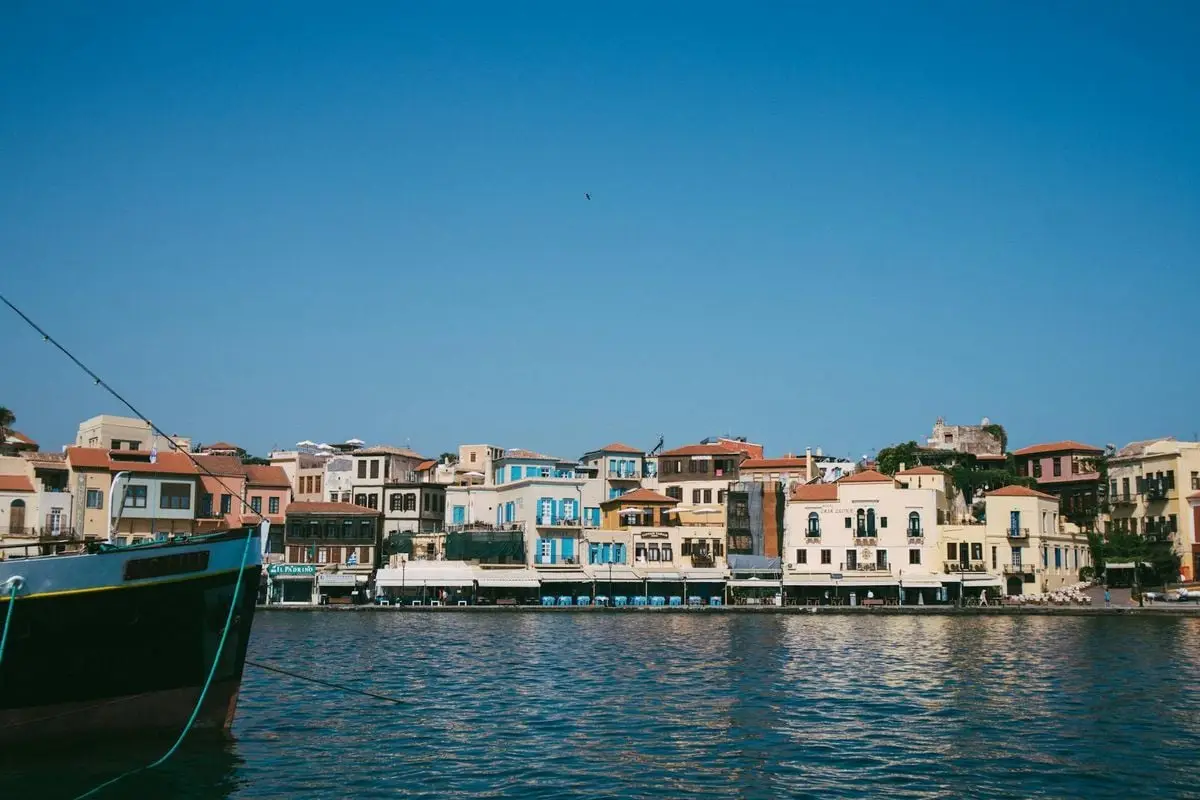 Scenic view of a charming harbor town with colorful buildings and clear skies, showcasing a picturesque waterfront.