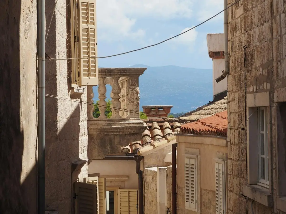 Charming stone architecture and rustic rooftops in a quaint Korčula alley.