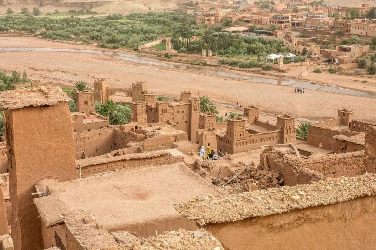 Explore the ancient Moroccan kasbah amid a stunning desert oasis. Ideal travel destination for history enthusiasts.