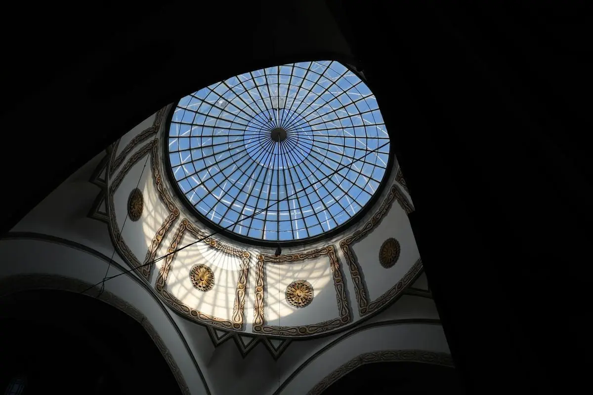 Captivating low angle view of an intricate glass dome ceiling in a historic cathedral.