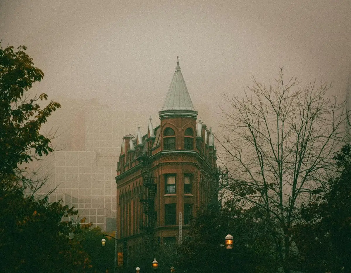 Atmospheric shot of Toronto's Flatiron Building surrounded by fog, capturing its classic architecture.