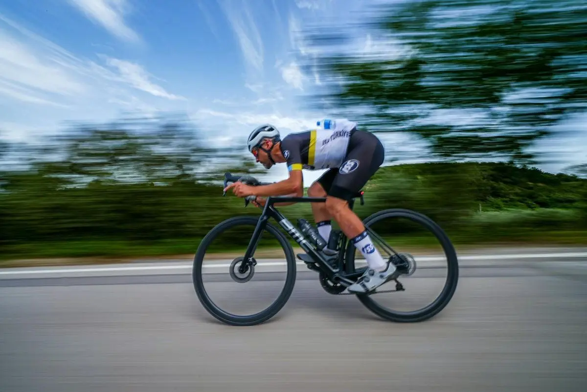 High-speed cyclist racing on rural road in Bursa, Türkiye showcasing athletic prowess.