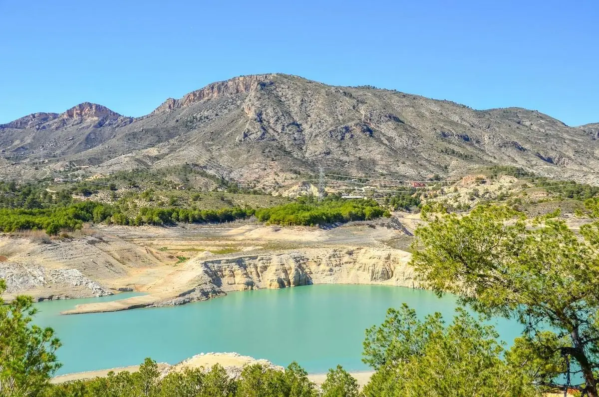 Breathtaking landscape of Villajoyosa's turquoise lake surrounded by rugged mountains.
