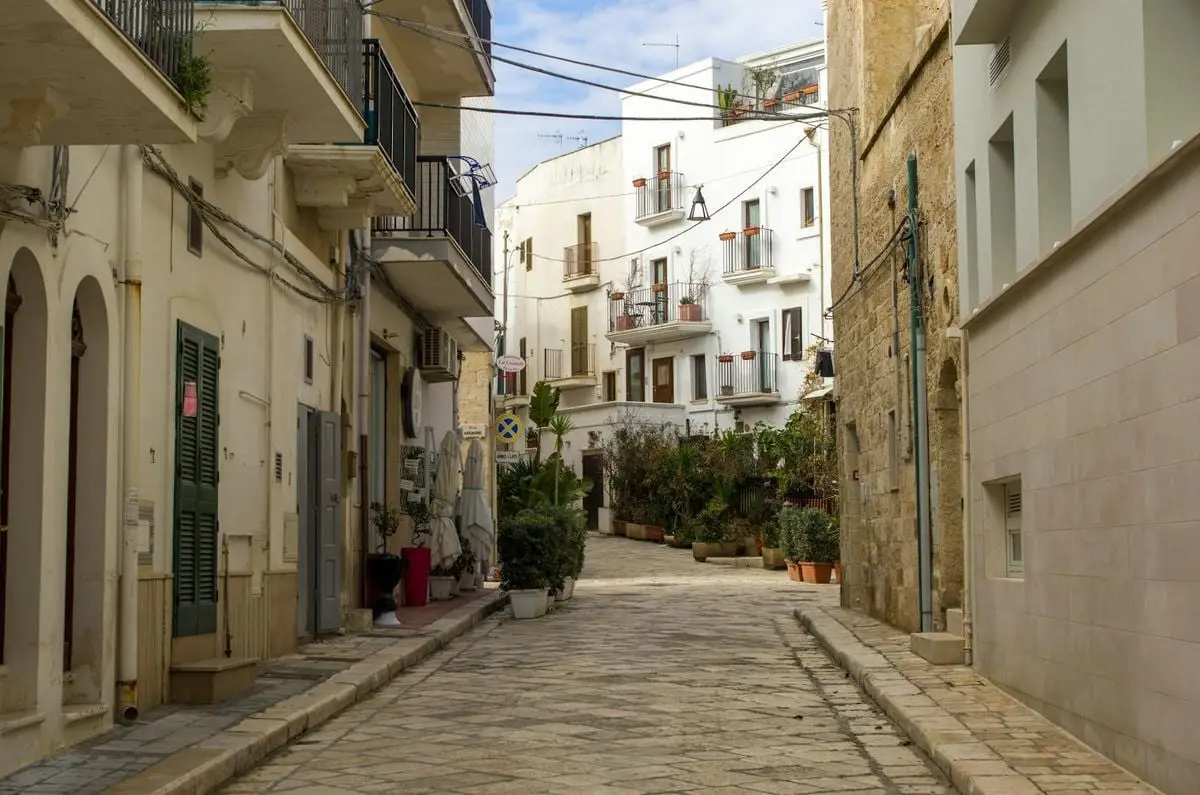 Scenic narrow street with Mediterranean architecture in a historic town.