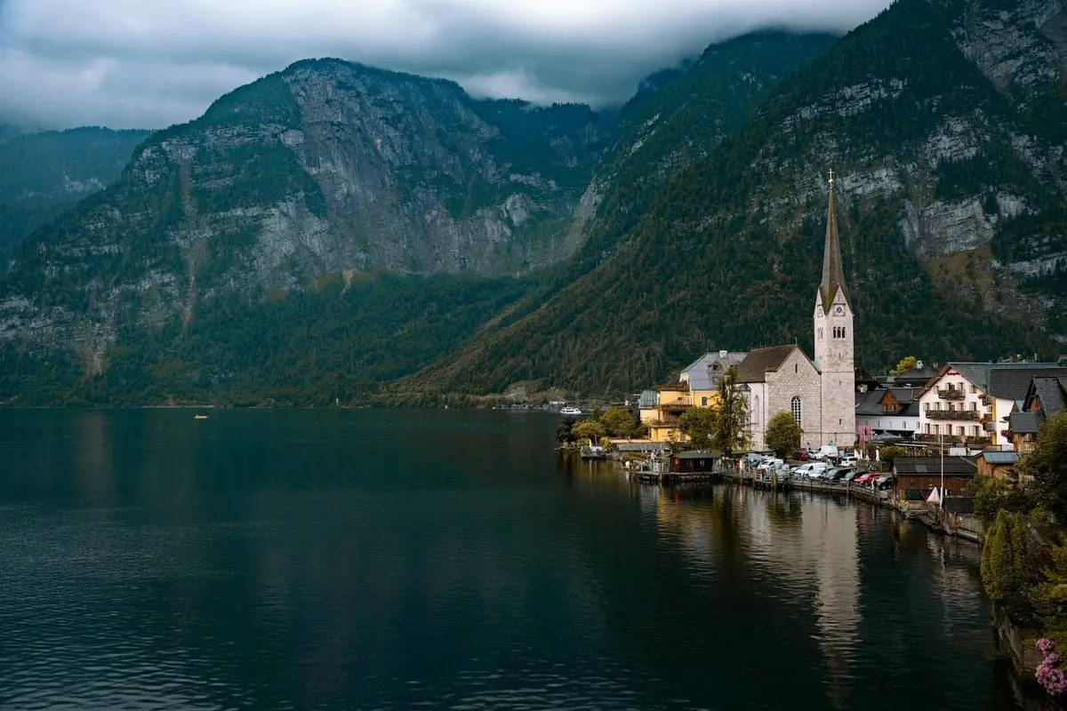 A picturesque view of Hallstatt village, Austria, with a serene lake and mountain backdrop.