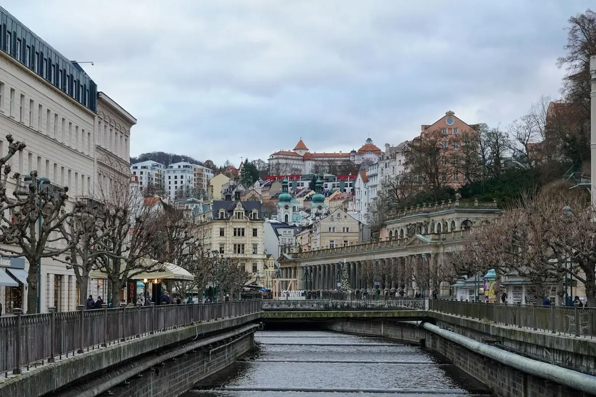 Discover the picturesque townscape of Karlovy Vary, Czech Republic, featuring historic architecture and a serene river.