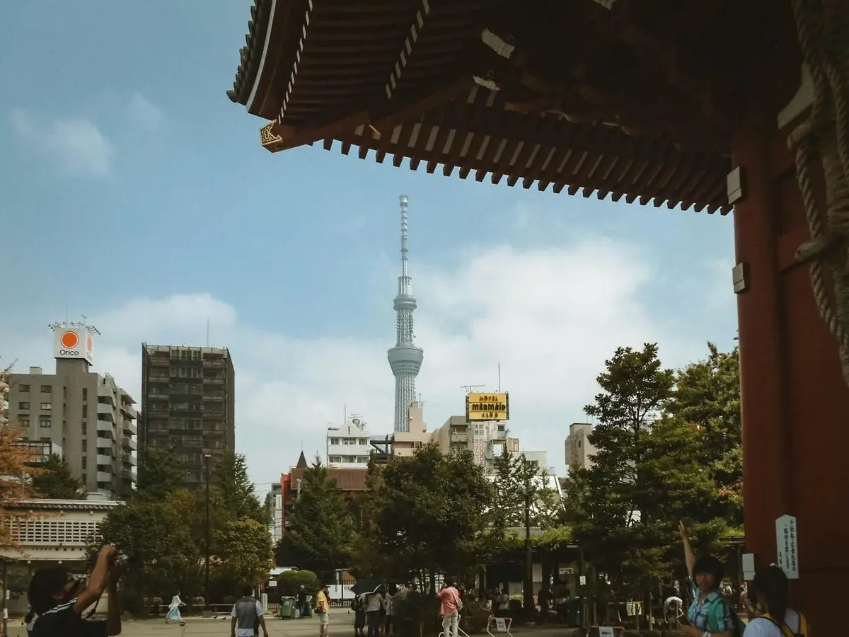 Scenic view of Tokyo Skytree framed by Senso-ji Temple architecture and city landscape.