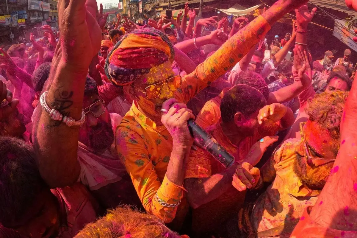 Joyous Holi celebration with colorful crowd in Kolkata, India, capturing the essence of cultural unity and happiness.