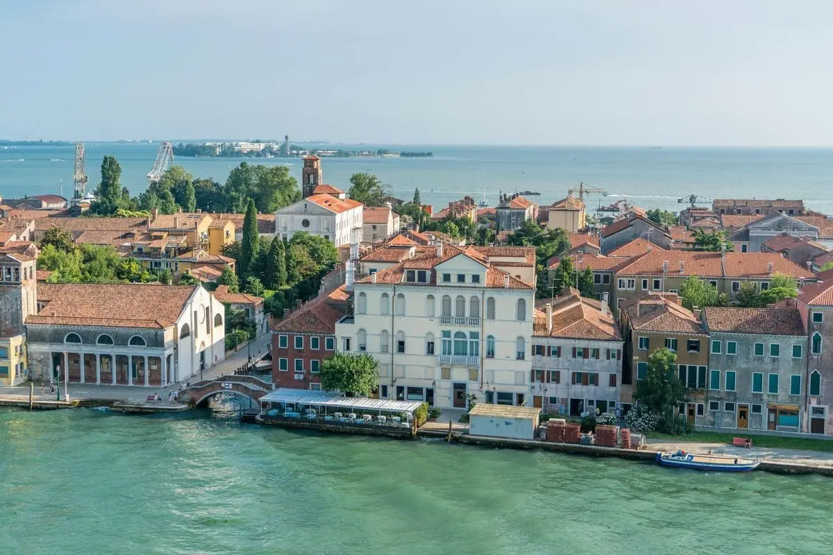 Scenic aerial view of Venice highlighting traditional architecture and calm lagoon waters.