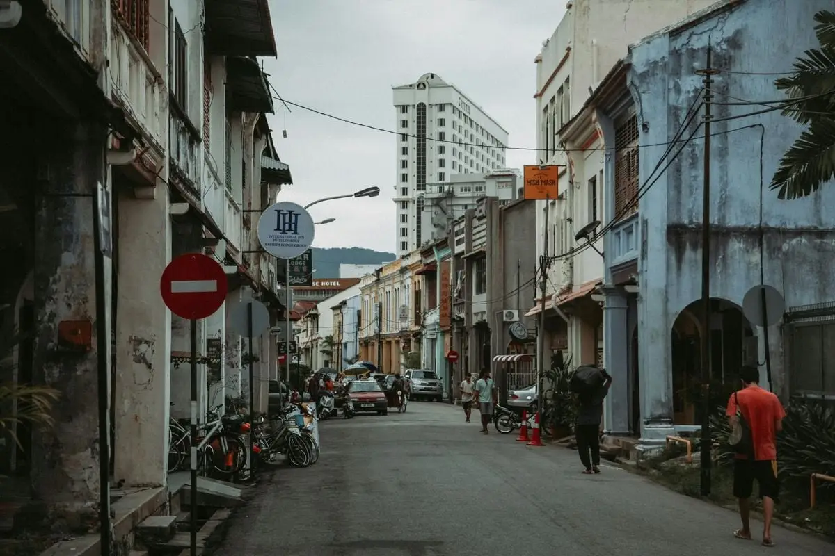Explore a lively, narrow street filled with historic charm, showcasing urban life and people.