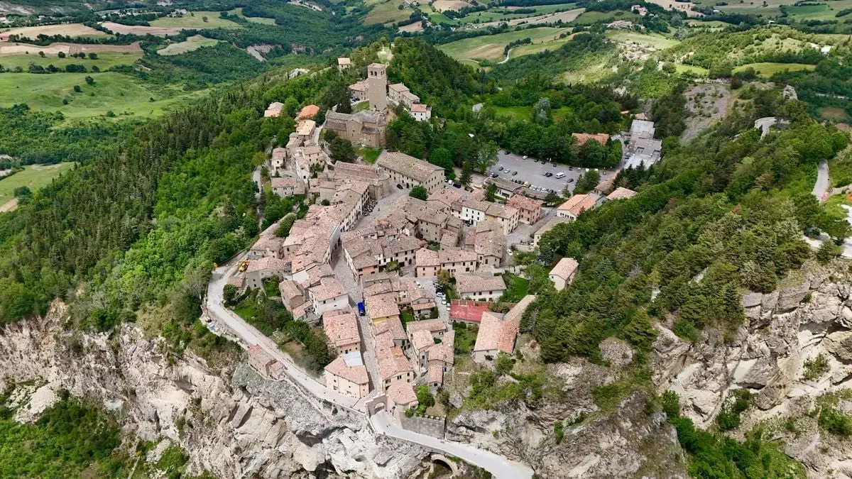 Breathtaking aerial shot of San Leo showcasing historic architecture amidst lush greenery.