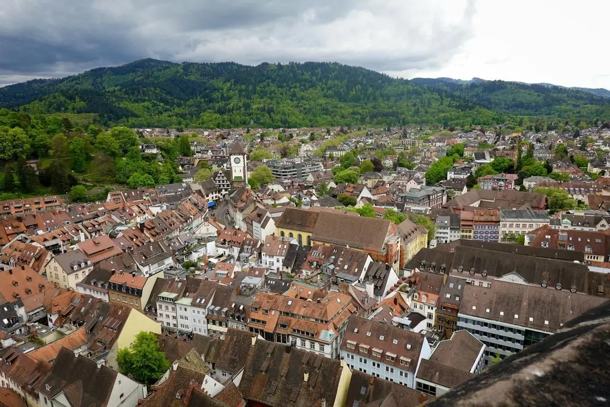 A breathtaking aerial view capturing the charming old town and lush green hills of a historic European village.