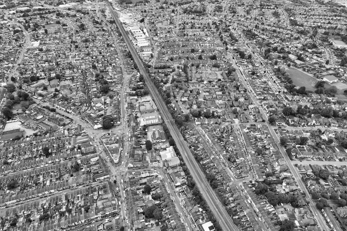 High-angle aerial photograph capturing the extensive cityscape of Luton, England in monochrome.