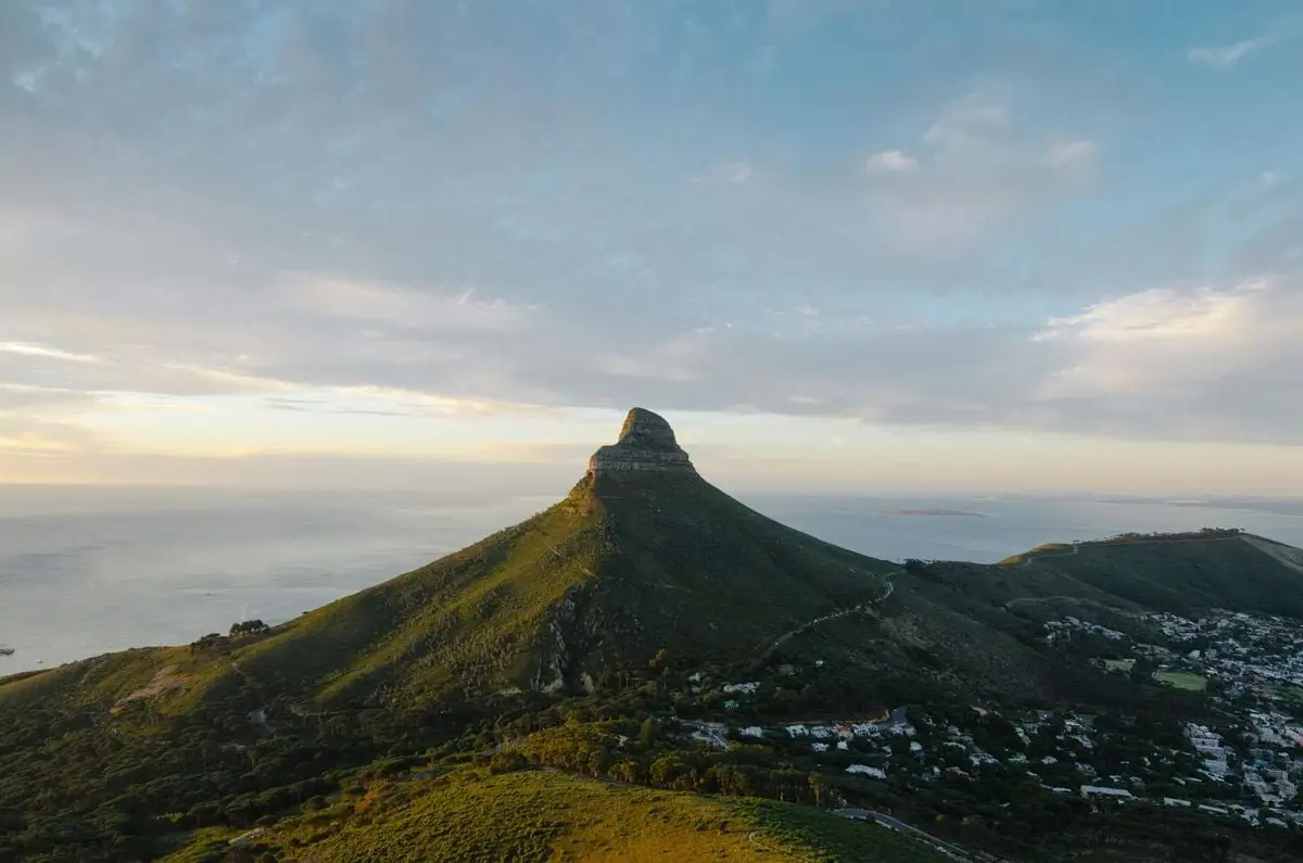 Capture of Lion's Head in Cape Town at sunset with ocean views.