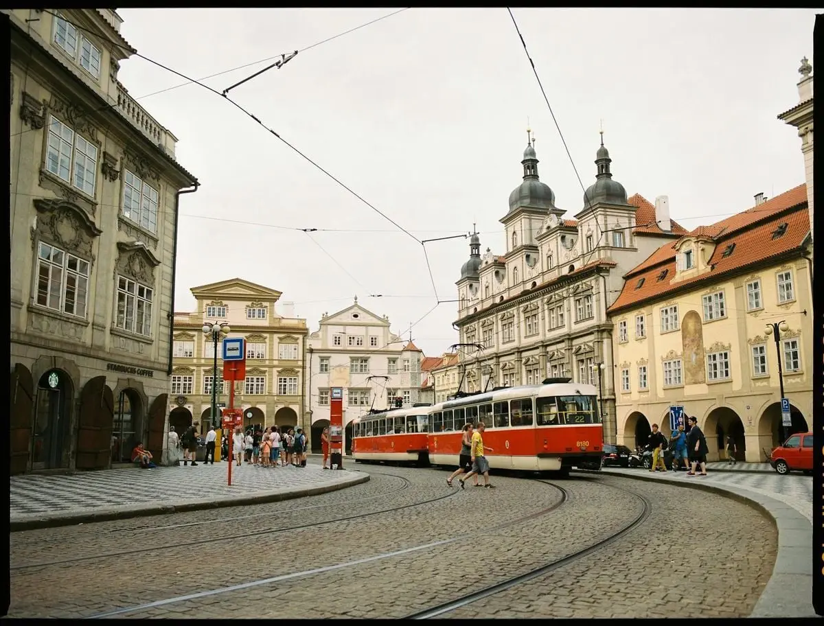Cobbled town square with vintage tram and historic buildings, a blend of travel and urban charm.