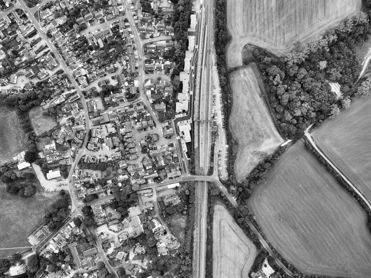 Black and white aerial view showcasing Harlington's urban and rural landscape.