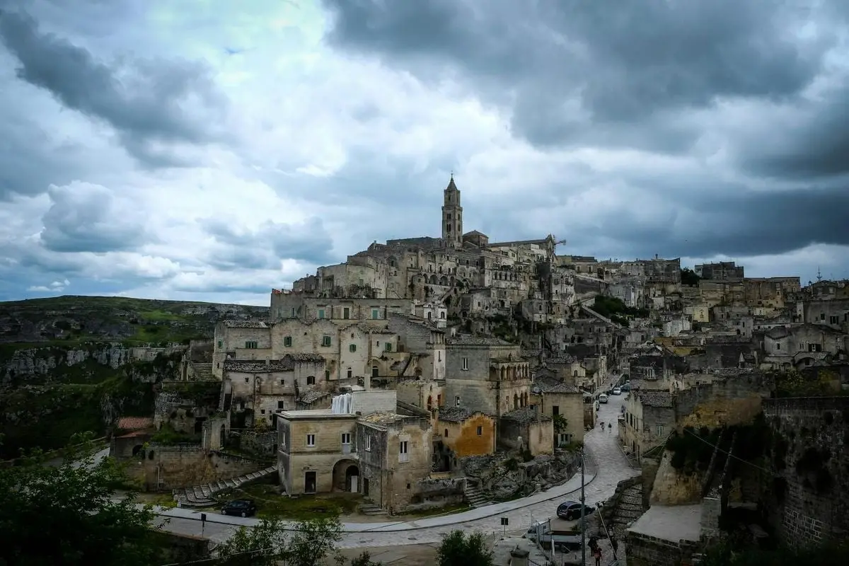 Historic Matera townscape with overcast sky, showcasing unique architecture.