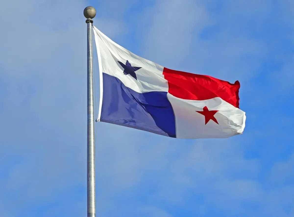 Panama flag waving against a clear blue sky, symbolizing patriotism and national pride.