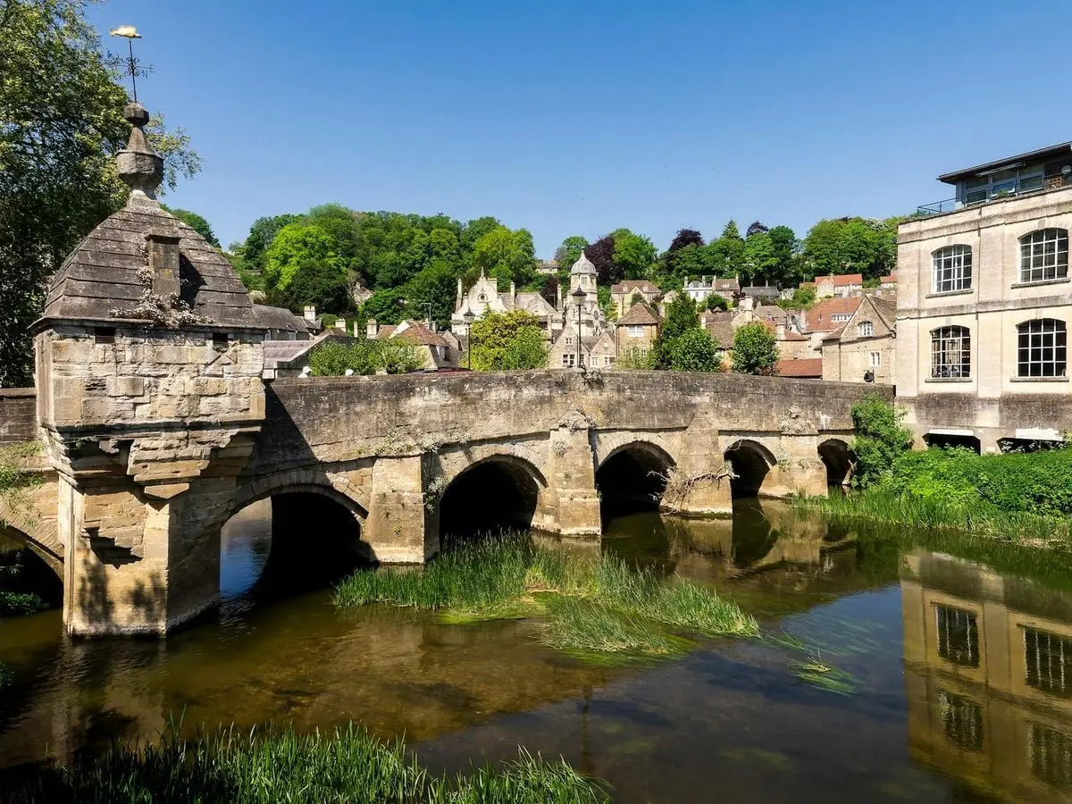 Charming stone bridge over river in sunny Bradford-on-Avon, England.