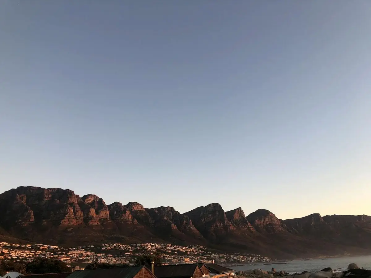 Scenic view of the Twelve Apostles mountain range at sunset in Cape Town, South Africa.