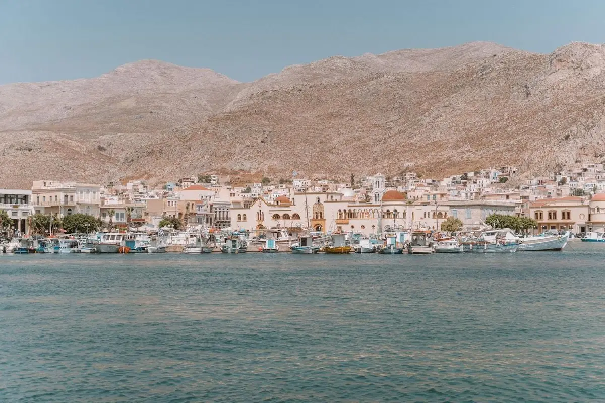 Explore the scenic beauty of Kalymnos Island's harbor with traditional architecture and calm waters.