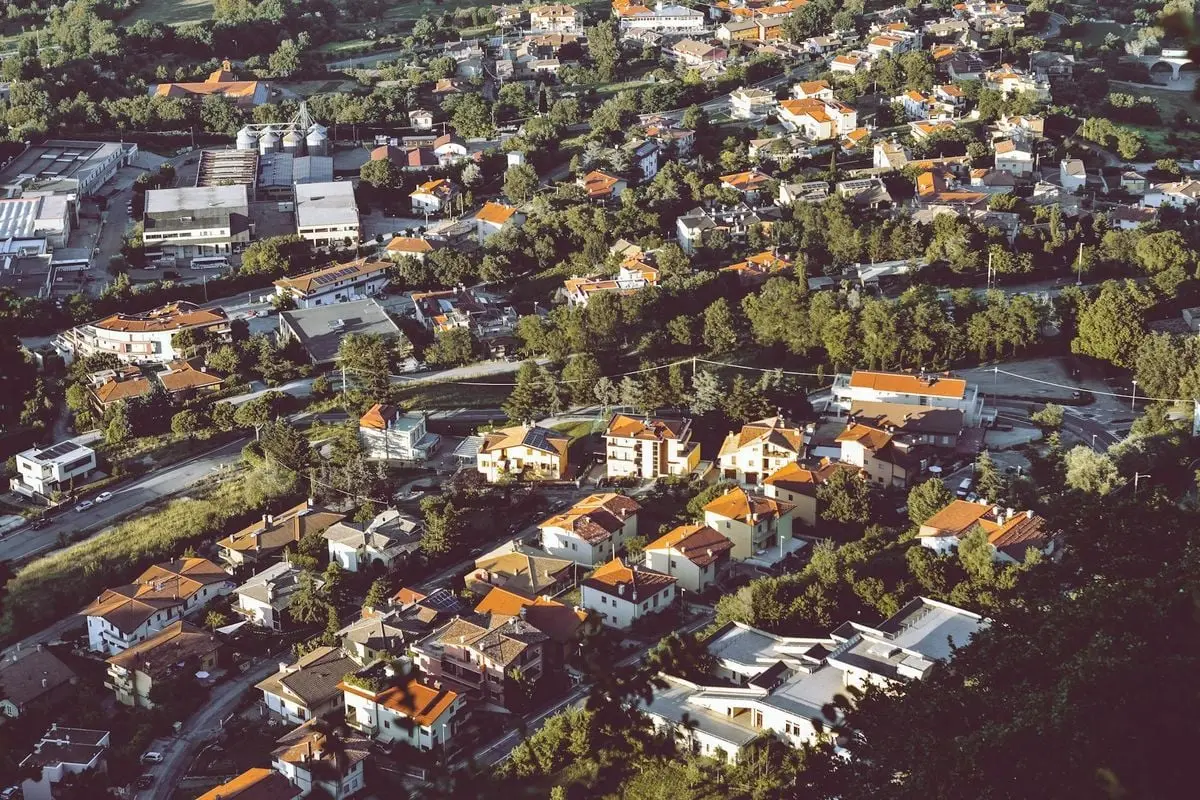 Scenic aerial view of San Marino's urban architecture surrounded by lush greenery, ideal for travel and tourism.