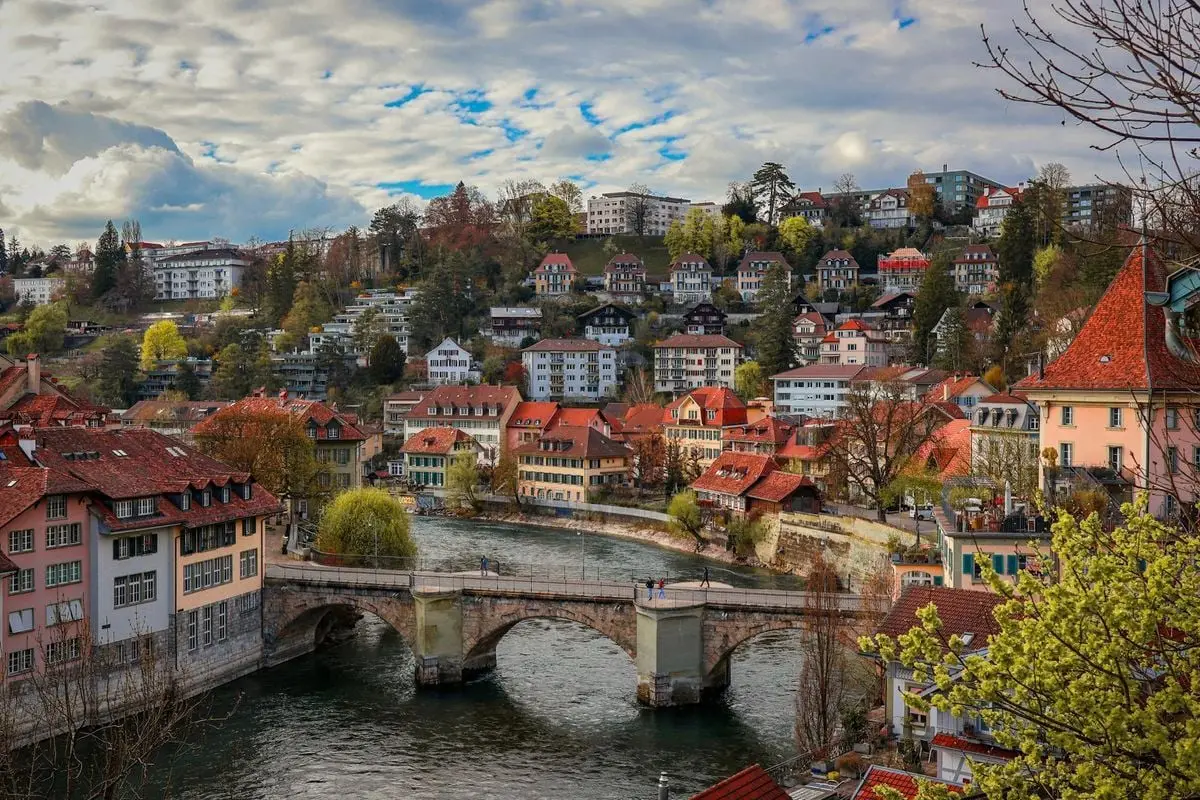 A picturesque aerial view of Bern, Switzerland featuring the Nydeggbrücke bridge over the Aare River.