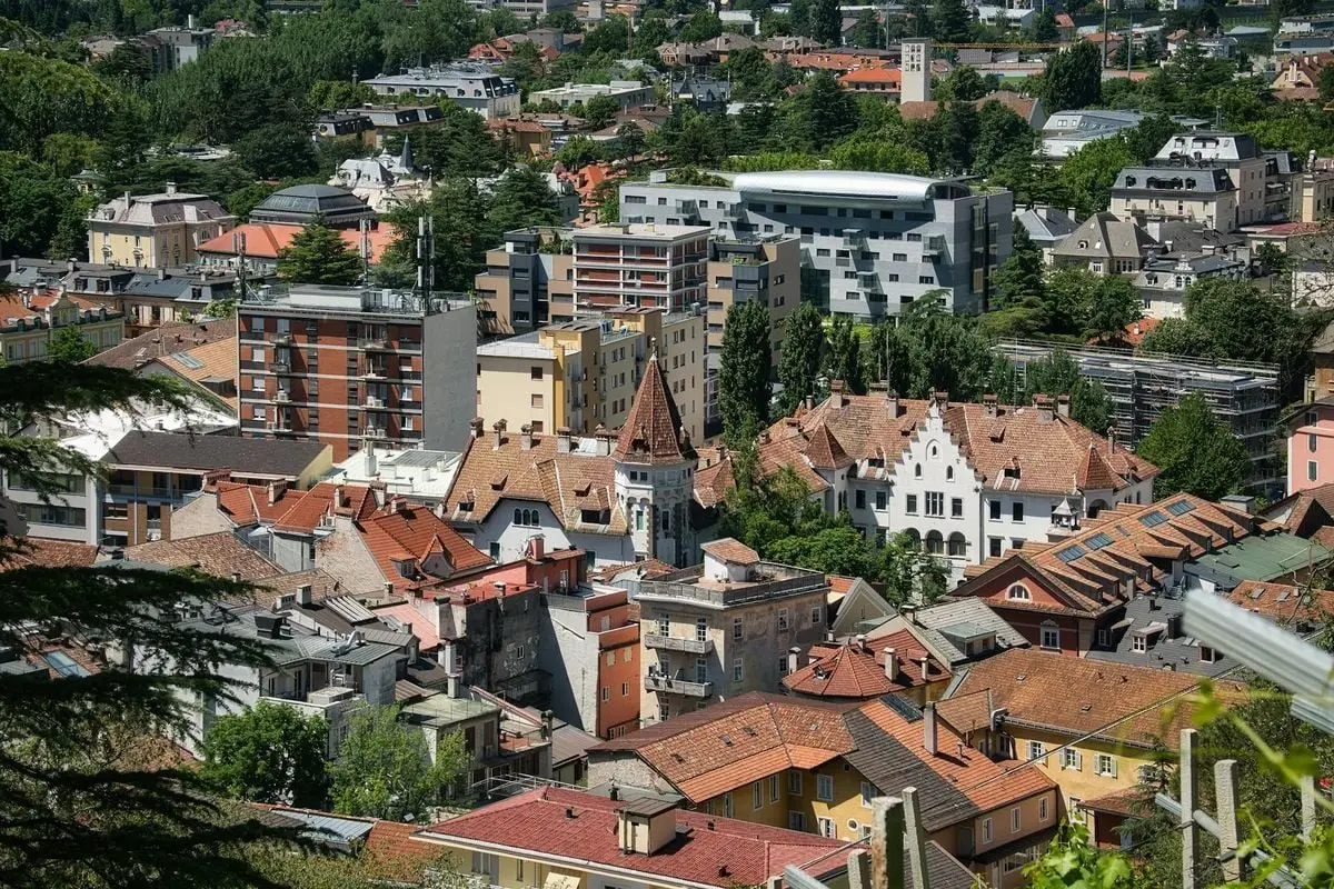 Explore the charming rooftops and architecture of Meran, South Tyrol from above in this captivating aerial photograph.