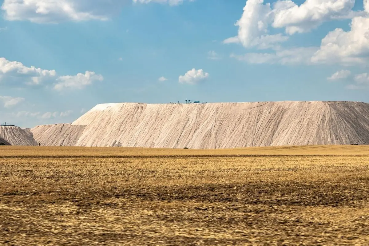 Expansive view of a salt mine with clear blue skies and scattered clouds creating a serene atmosphere.