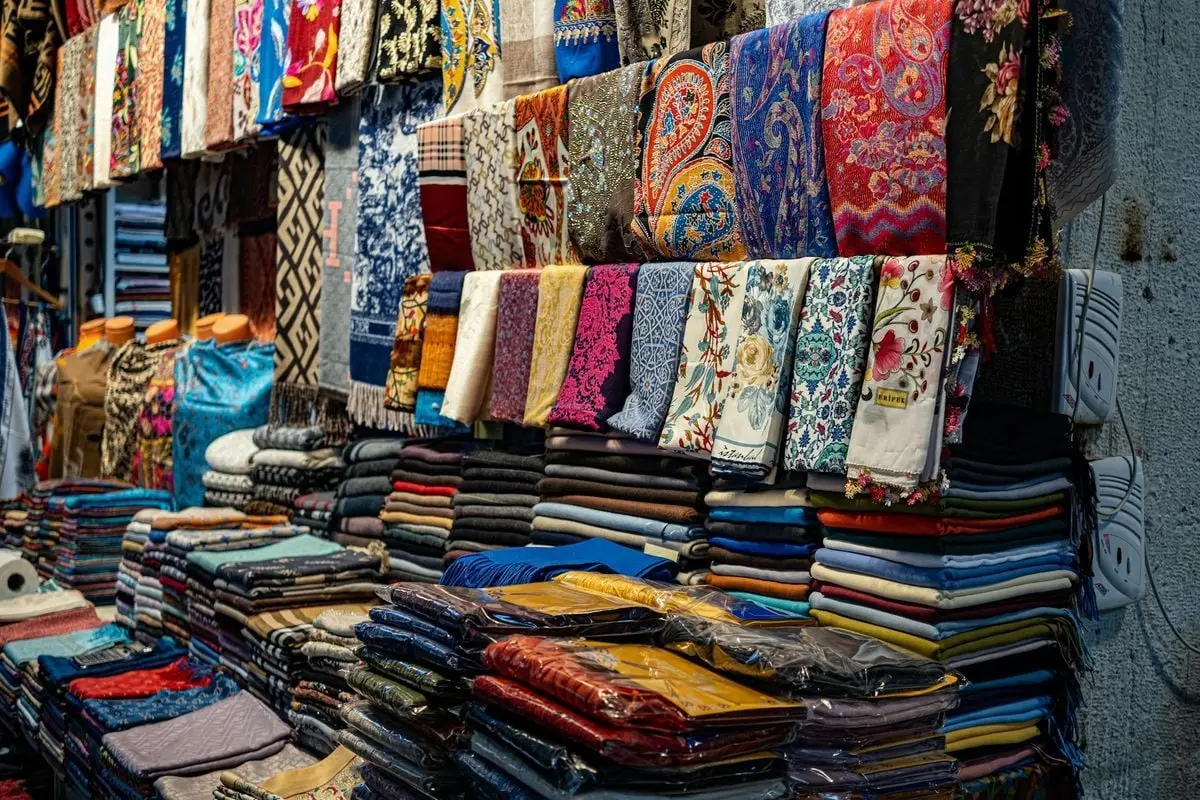 A colorful array of fabrics and headscarves displayed at an Istanbul market, showcasing local culture.